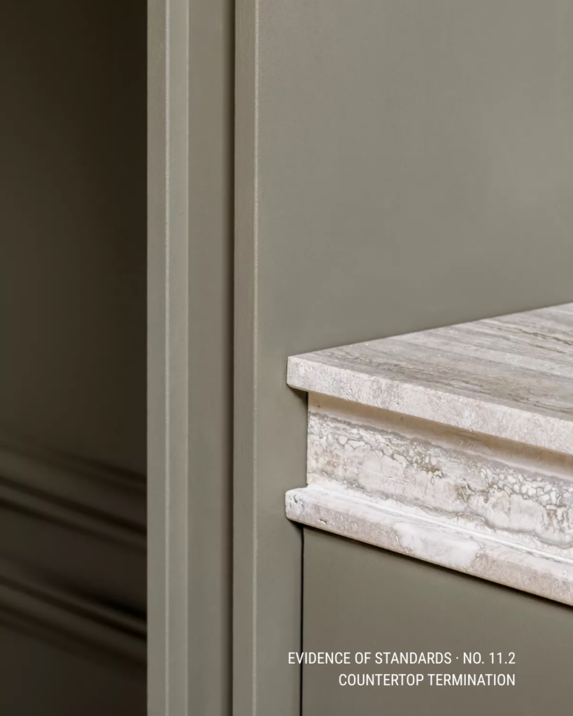 Stone countertop termination aligned cleanly with painted millwork to preserve the architect's intended detail.