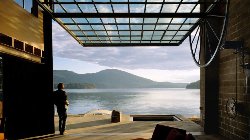 Operable wall framing a lake view in an Olson Kundig residence.